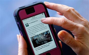 Person reading news on a smartphone.