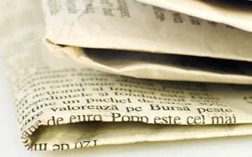 Stack of folded newspapers, close-up view.