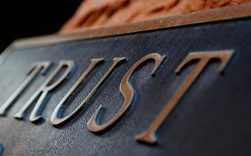 Close-up of the word Trust on sign.