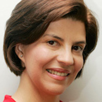Smiling person with short brown hair.